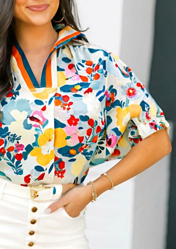 Woman wearing a colorful floral blouse with a blurred background