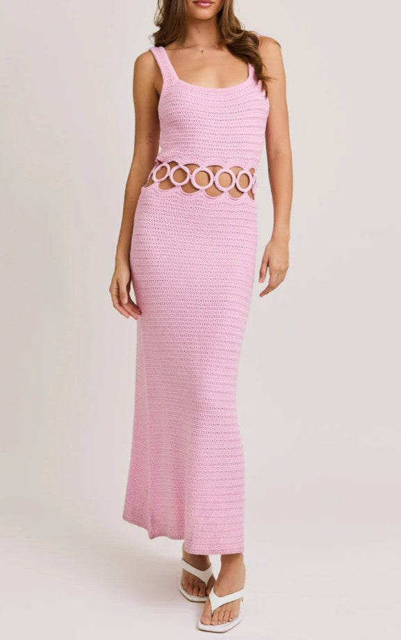 Pink dress with cut-out design on a white background