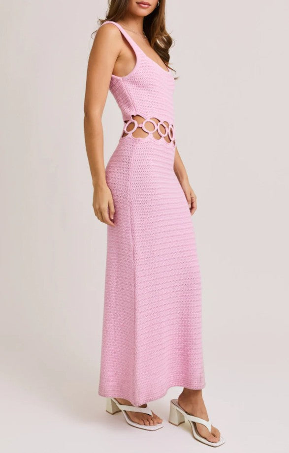 Pink dress with cut-out design on a white background