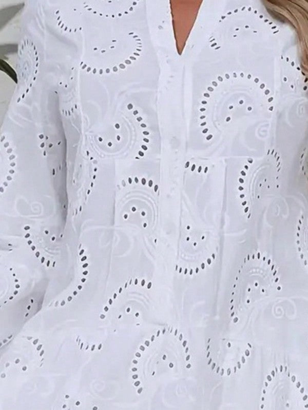White embroidered blouse with intricate patterns on a blurred background