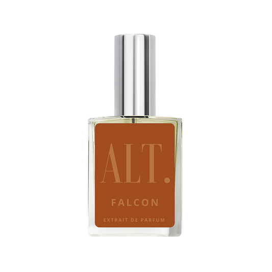Perfume bottle with brown label and silver cap on white background
