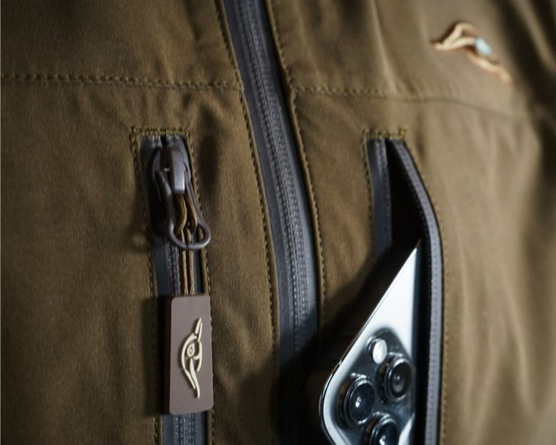 Close-up of a brown jacket with a zipper and visible brand logo.