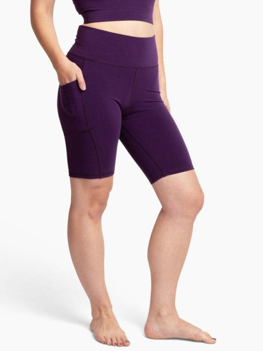 Person wearing purple athletic shorts on a white background